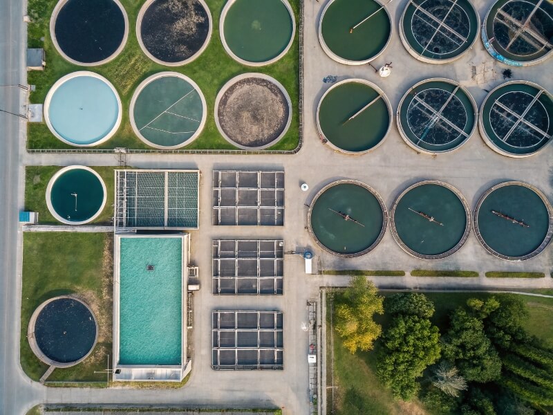 Aerial view of multiple circular aquaculture tanks, demonstrating an organized fish farming facility