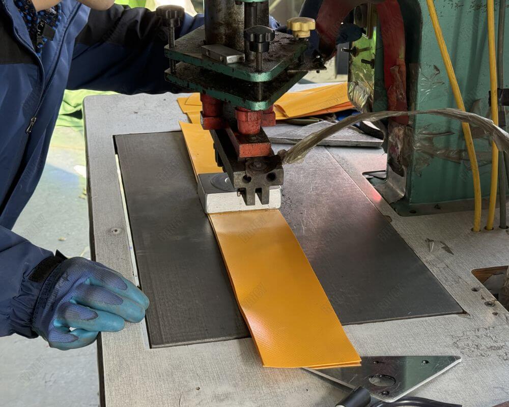 Pre-cut materials for aquaculture tanks laid out in a workshop