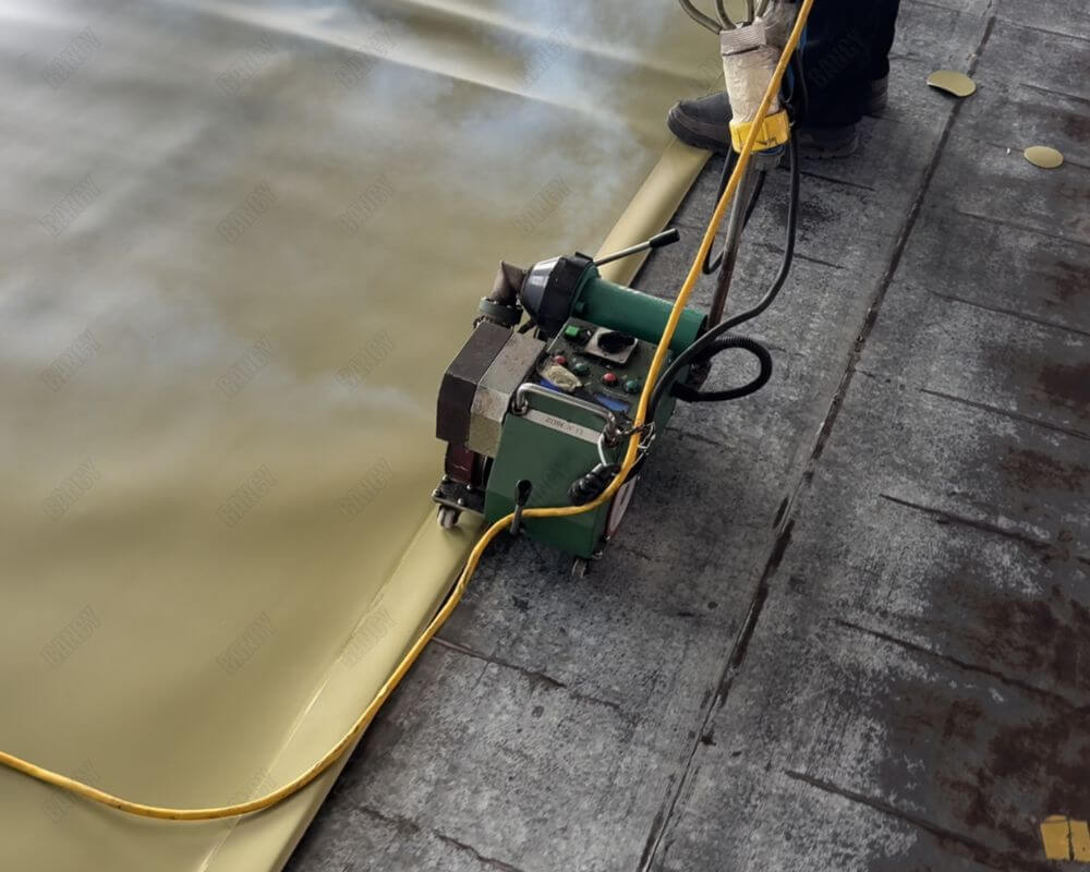 Welding equipment being used to heat seal materials for tank construction