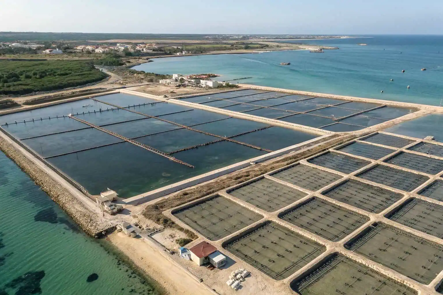 An aerial view of a fish farm with many ponds