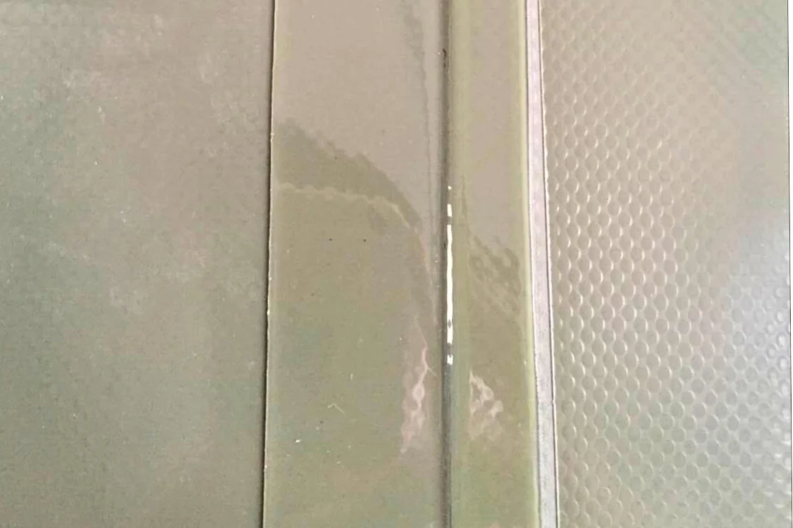 Macro view of Double-Layer Reinforced Seam Technology featuring a secondary reinforcement strip for a leak-resistant fuel bladder.