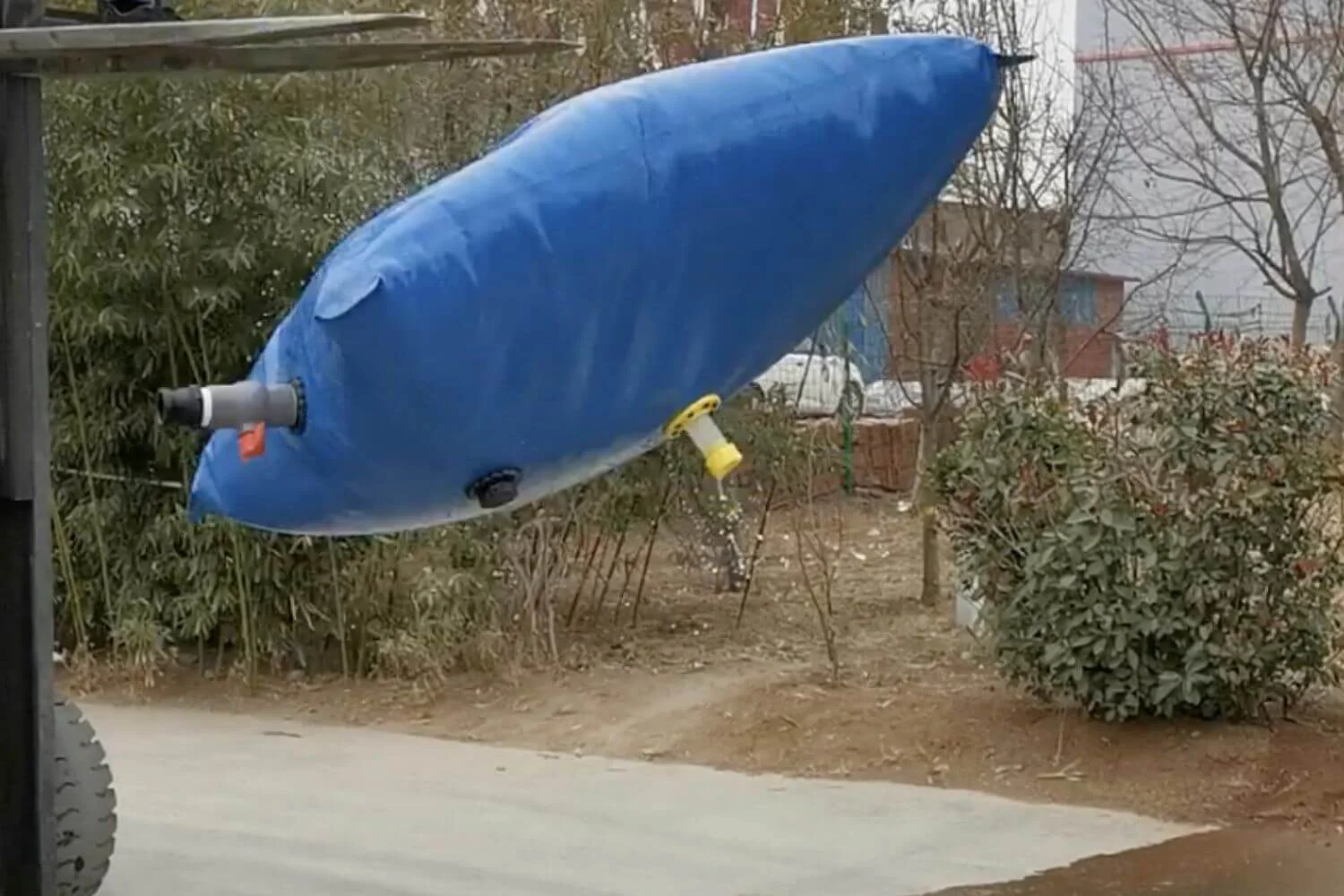 Field testing of reinforced flexible tanks on rocky ground to demonstrate durability for industrial liquid containment.