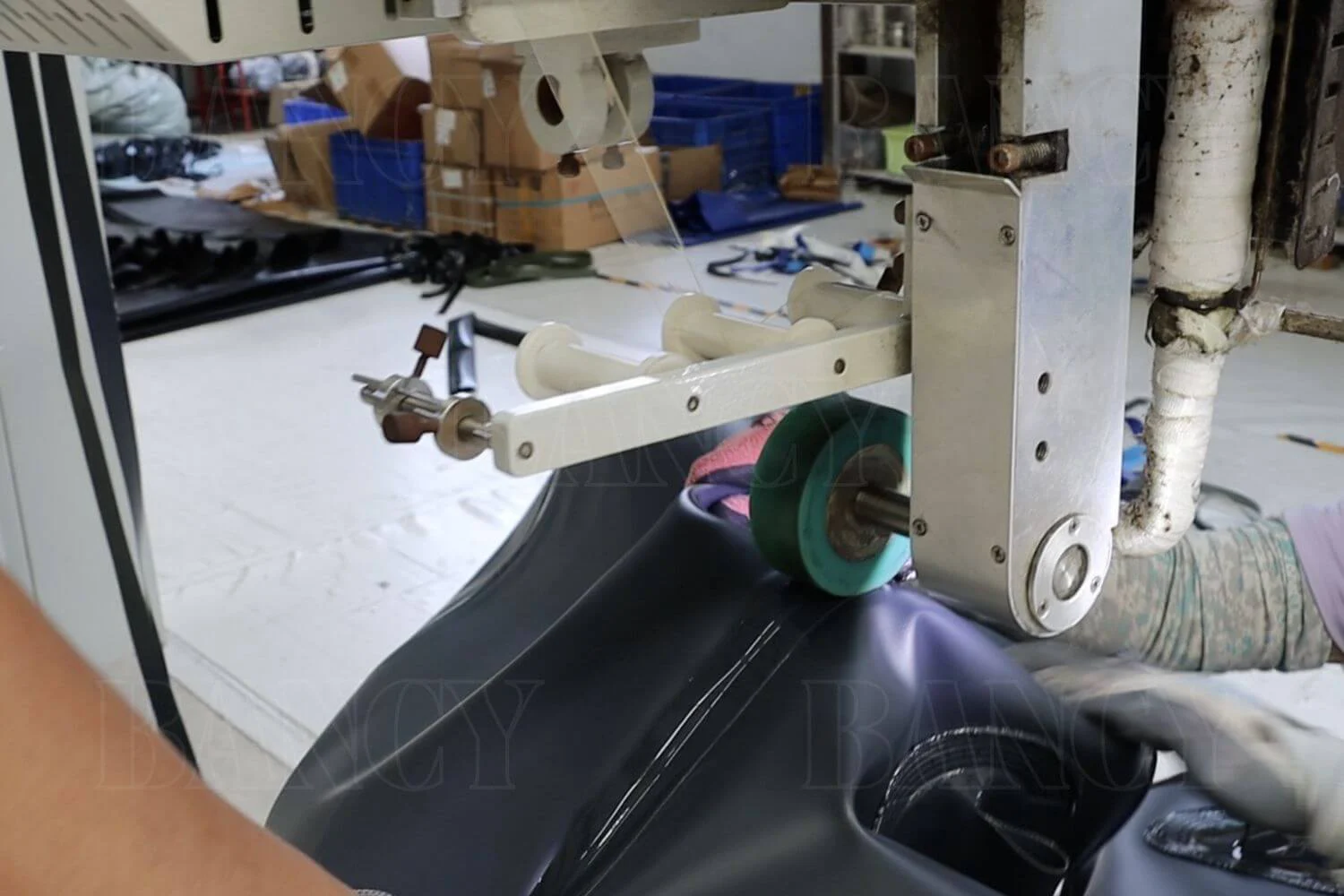 Close-up of a technician performing the proprietary Double-Weld process on a flexible tank seam to reinforce structural integrity.