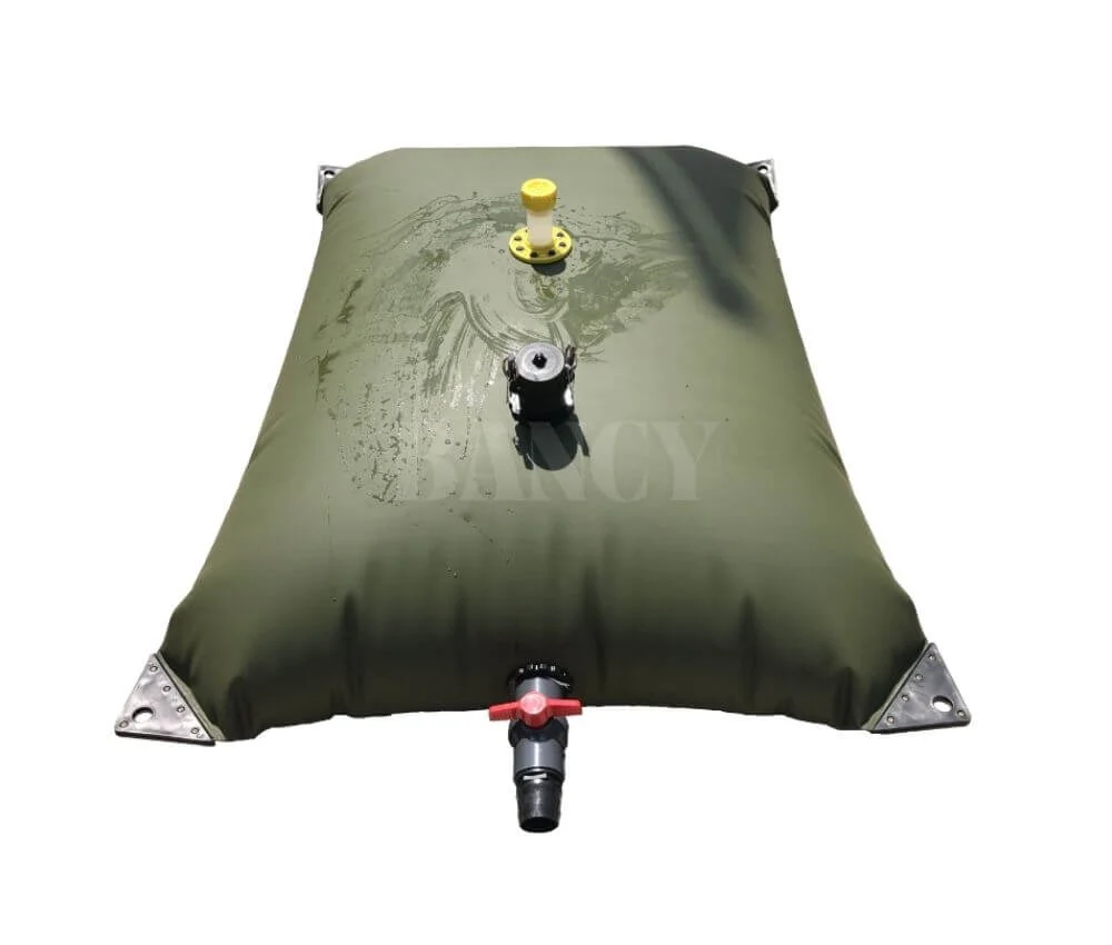 Front view of a green pillow-shaped collapsible water tank showing top filling port and bottom outlet valve.