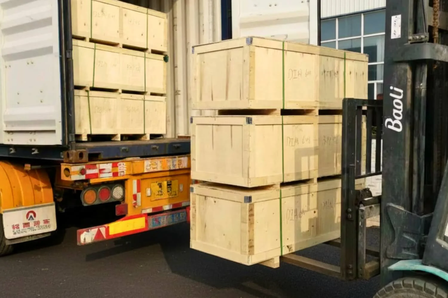 Forklift moving wooden crates containing flexible tanks for export