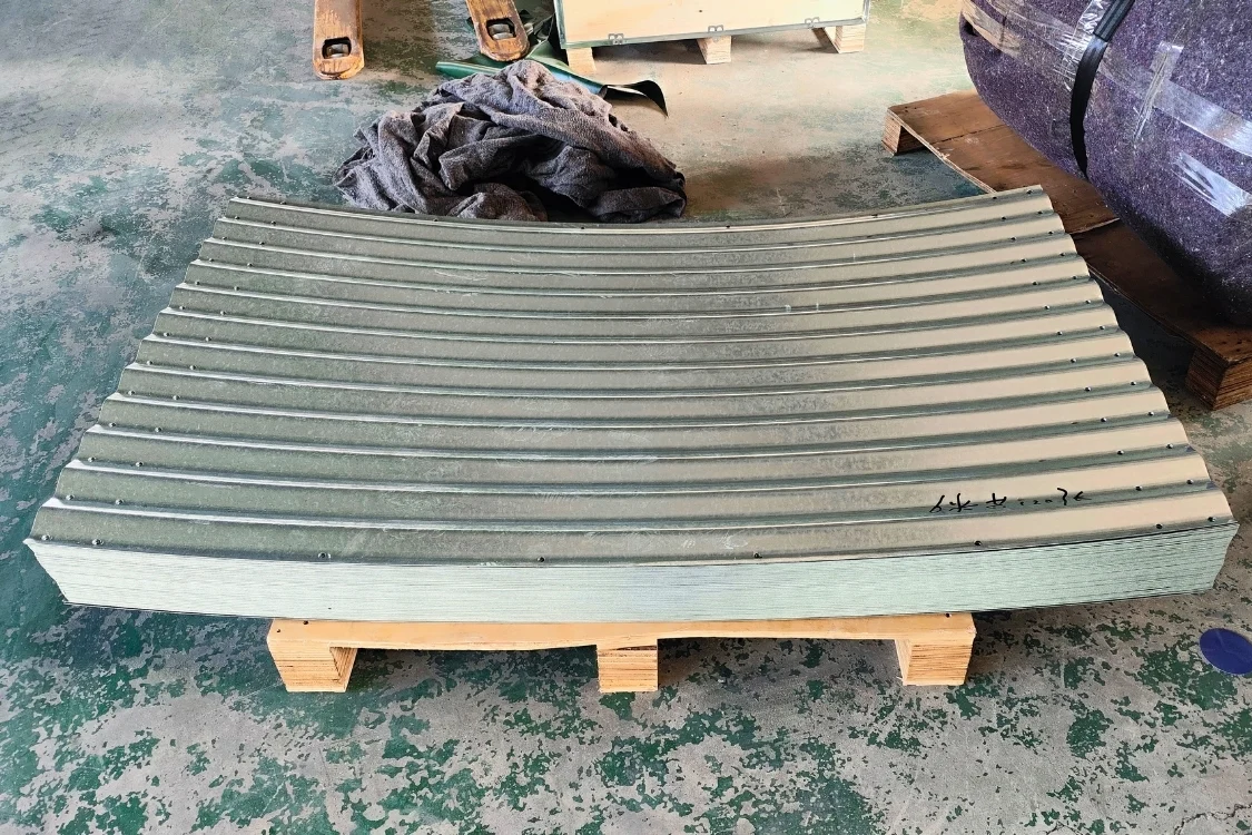 Compact flat-pack pallet of corrugated galvanized steel tank panels wrapped for export shipping to save freight.