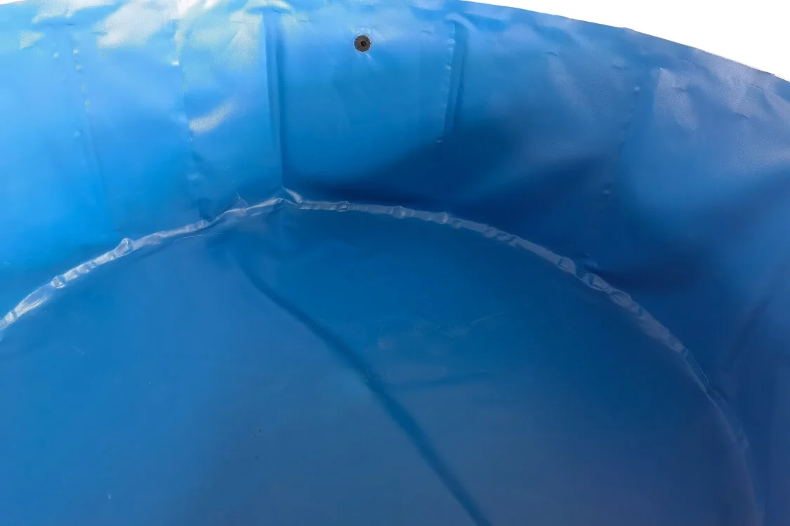 Close-up of water inside the blue PVC tank showing smooth heat-fused seams and leak-proof integrity.