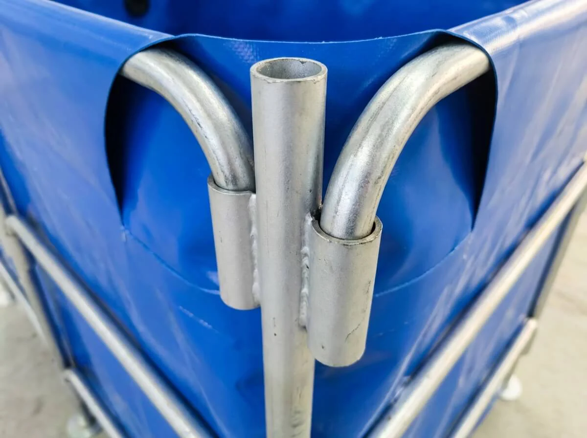 Extreme close-up of the thick galvanized steel connection points on the nursery tank frame.