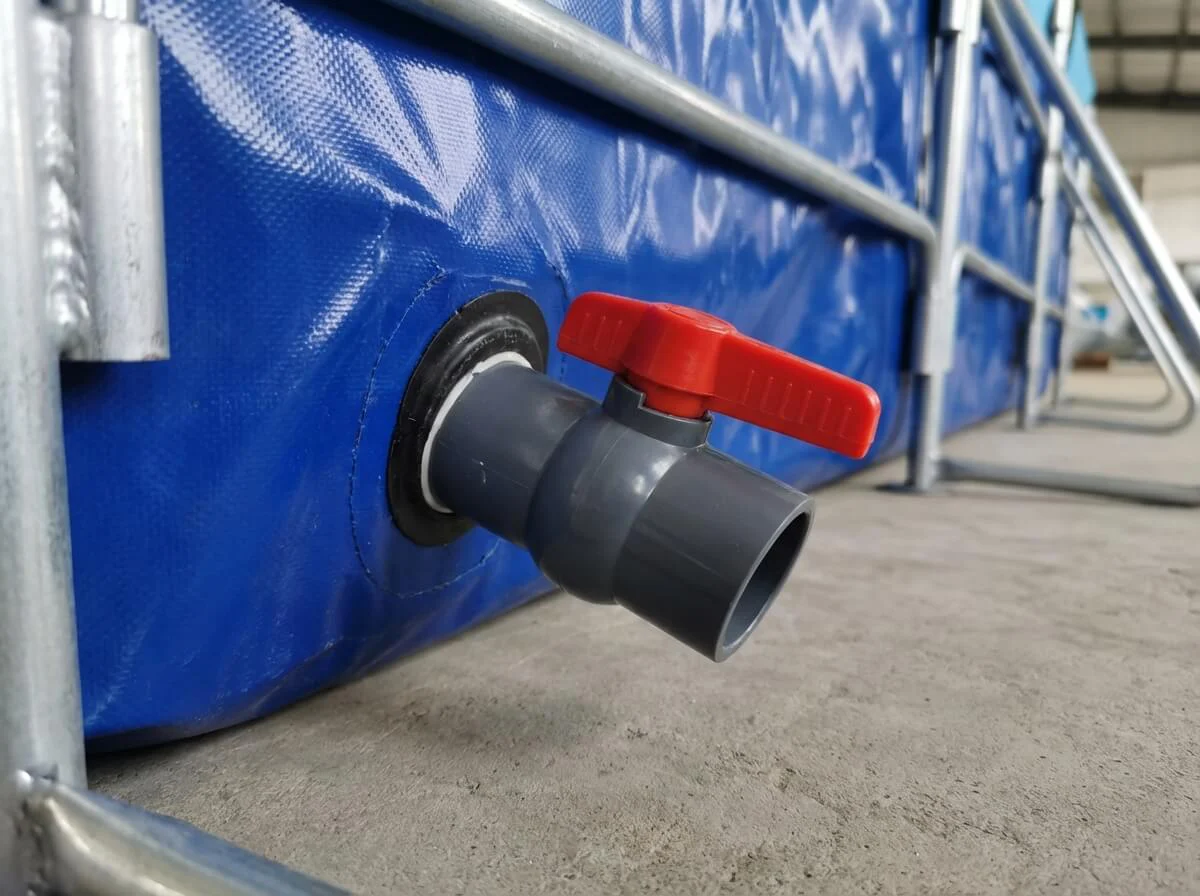Heavy-duty large diameter ball valve connected to the bottom of the blue aquaculture tank.