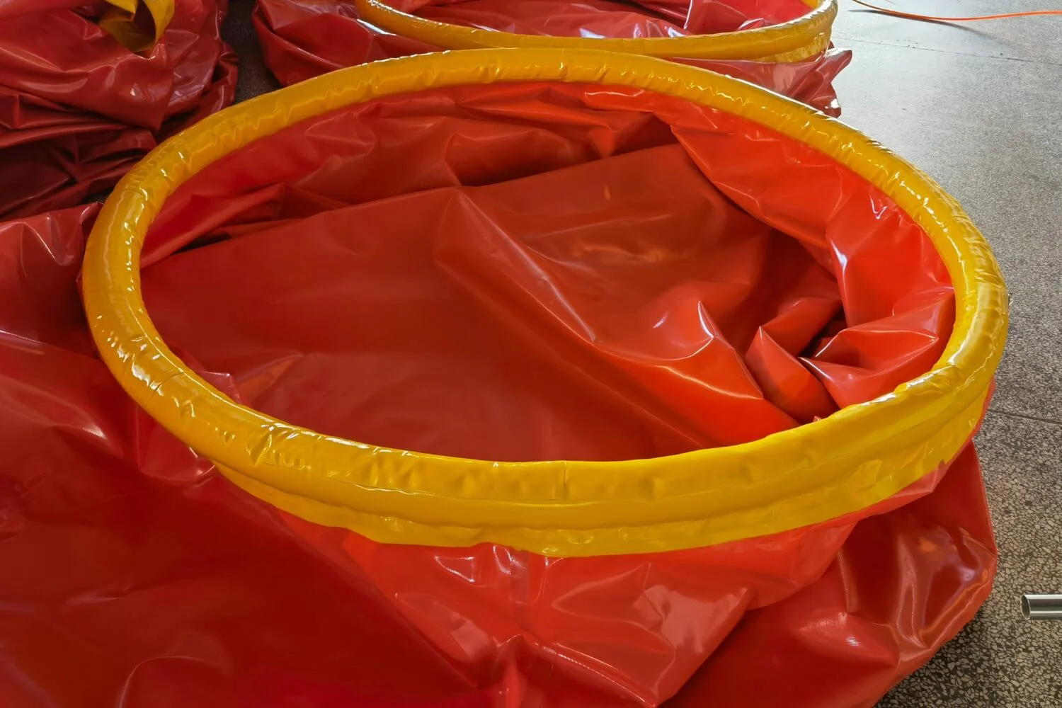 Close-up of heavy-duty closed-cell foam collar on orange onion tank showing material density