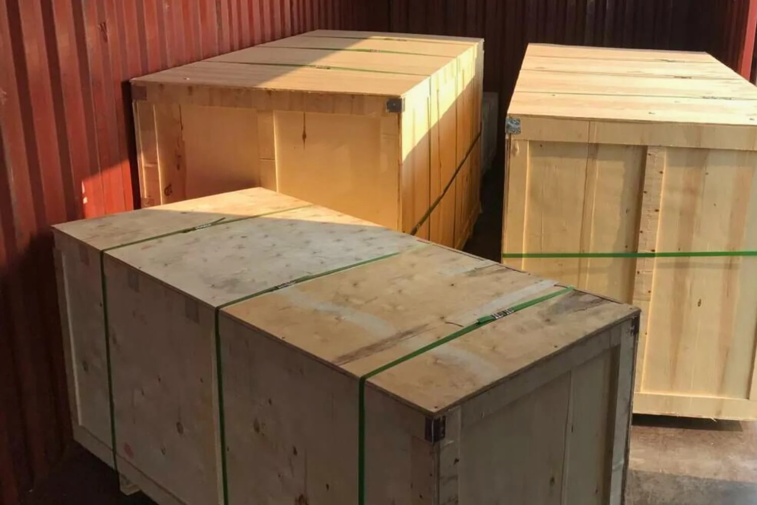 Folded collapsible water tank in a small wooden crate ready for low-cost shipping