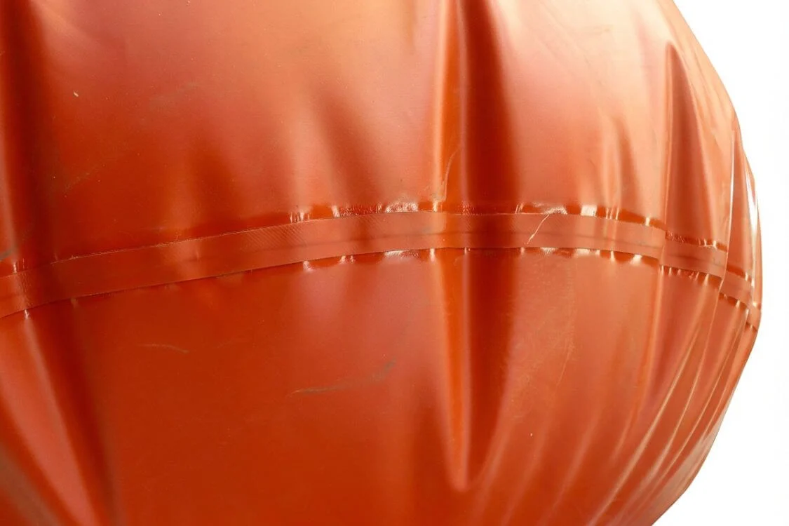 Double-layer reinforced welded seam on a red biogas bag