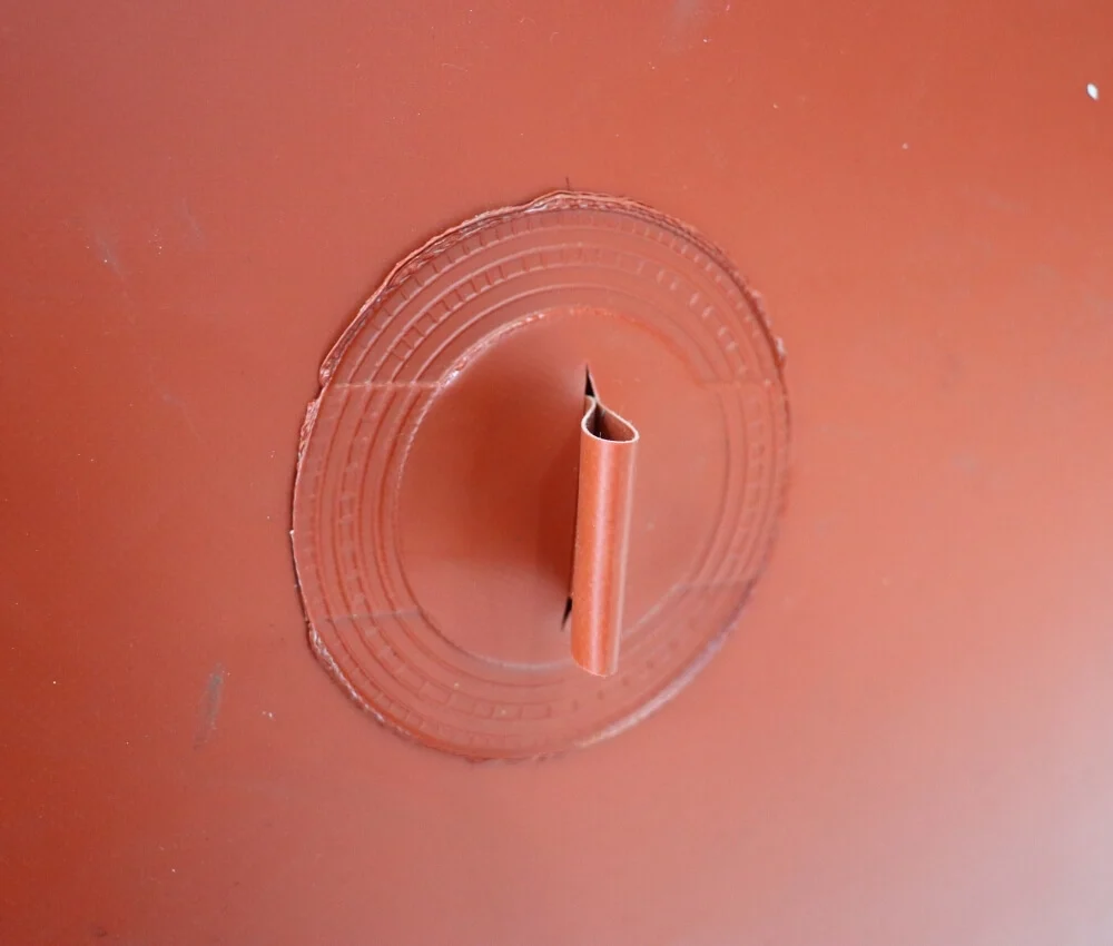 Close-up of double-layer reinforced welded port on a red biogas bag