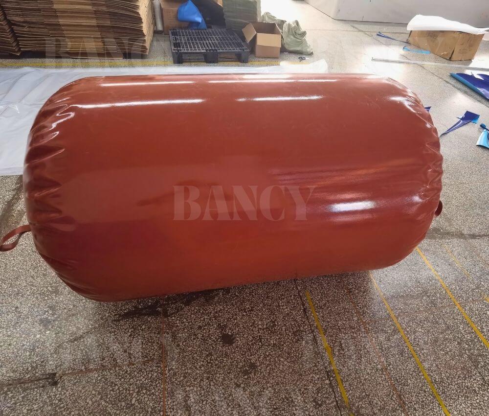 Side view of a large tubular red mud PVC methane capture bag inflated in the Bancy factory.