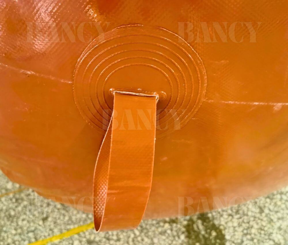 Detail of the reinforced tie-down handle on a scalable flexible gas holder by Bancy.