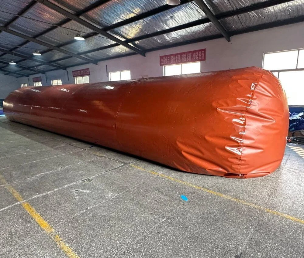 Extremely long inflated red mud biogas storage tank inside a Bancy manufacturing facility.